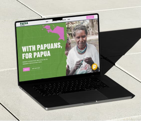A laptop displaying Papua Partners website